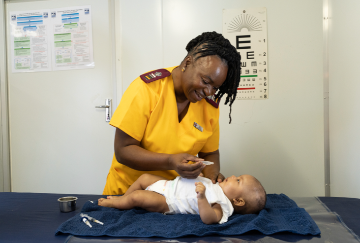 Caption: Sister Pat and child. Photo credit: Unjani Clinic